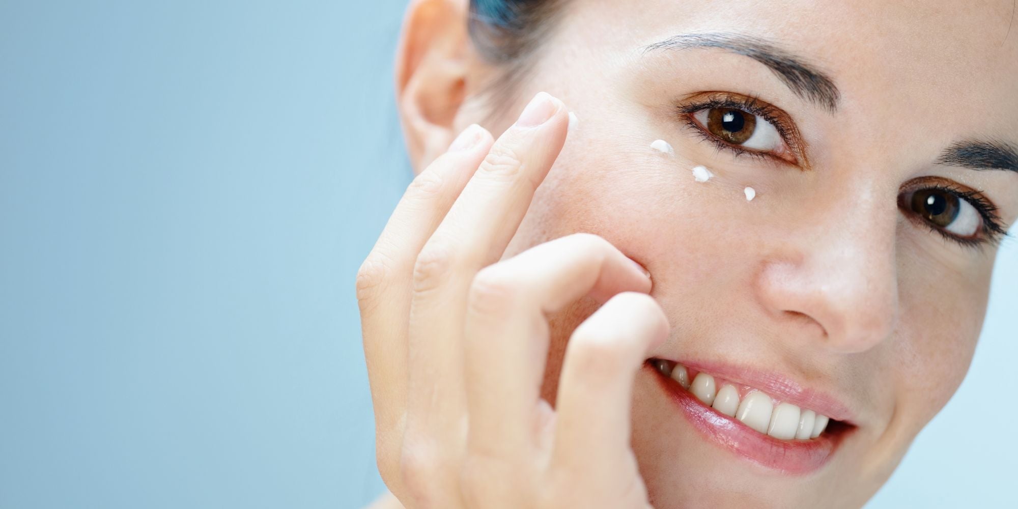 Femme qui utilise une crème contour des yeux